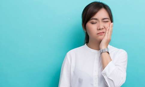 Woman in pain from TMJ