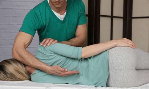 Woman receiving chiropractic adjustment.