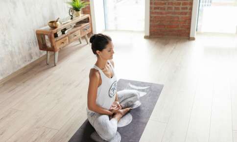 Woman meditating in a peaceful room